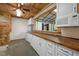 Kitchenette with wood ceiling, long countertops, white cabinets, and appliances at 3603 Westmeadow Ln, Elon, NC 27244