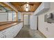 Kitchenette with wood ceiling, long countertops, white cabinets, and appliances at 3603 Westmeadow Ln, Elon, NC 27244