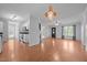 Open-concept living area with hardwood floors, a fireplace, and seamless flow to the kitchen at 3603 Westmeadow Ln, Elon, NC 27244