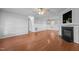 Spacious living room with hardwood floors, a fireplace, and modern accents, ideal for entertaining at 3603 Westmeadow Ln, Elon, NC 27244