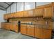 Long wooden workbench and cabinets with overhead lights in converted garage space at 3603 Westmeadow Ln, Elon, NC 27244