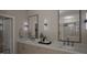 Modern bathroom with double sink vanity, marble countertops, matching mirrors, and walk in shower at 389 Deer Tail Ln # 39, Fuquay Varina, NC 27526