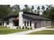 Modern home with gray siding, white brick accents, and a well-manicured lawn surrounded by mature trees at 389 Deer Tail Ln # 39, Fuquay Varina, NC 27526