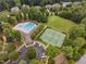 Aerial shot of community pool, tennis courts, field, and parking at 39 Forked Pine Ct, Chapel Hill, NC 27517