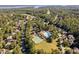Wonderful aerial view showcasing the tennis courts, pool and nearby residential homes at 39 Forked Pine Ct, Chapel Hill, NC 27517