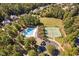 Great aerial view featuring the swimming pool, tennis courts and green space at 39 Forked Pine Ct, Chapel Hill, NC 27517