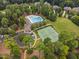 Aerial view features a swimming pool, tennis courts, a green space and parking lot at 39 Forked Pine Ct, Chapel Hill, NC 27517