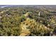 Stunning aerial view of golf course surrounded by lush green trees and waterfront community at 39 Forked Pine Ct, Chapel Hill, NC 27517