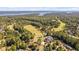 Beautiful aerial view of golf course with clubhouse and lake in the background at 39 Forked Pine Ct, Chapel Hill, NC 27517