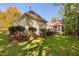 Well-maintained backyard with lush lawn, mature shrubs, and a screened-in porch area at 39 Forked Pine Ct, Chapel Hill, NC 27517