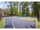 Beautiful basketball court surrounded by lush trees providing shade to players at 39 Forked Pine Ct, Chapel Hill, NC 27517