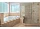 The bathroom boasts a large tub with tile surround and glass enclosed shower at 39 Forked Pine Ct, Chapel Hill, NC 27517
