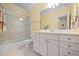 Bright bathroom features a tub with glass doors and white vanity, perfect for a refreshing cleanse at 39 Forked Pine Ct, Chapel Hill, NC 27517