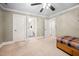 Bedroom with carpeted floor, ceiling fan, bed and study area, offering a simple, relaxing space at 39 Forked Pine Ct, Chapel Hill, NC 27517