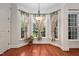 Breakfast nook area with a three-window bay, hardwood floors, and decorative curtains, creating a cozy spot at 39 Forked Pine Ct, Chapel Hill, NC 27517
