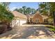 Charming single-story home featuring stone accents, a well-manicured lawn, and a long driveway at 39 Forked Pine Ct, Chapel Hill, NC 27517