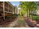 Exterior rear view of the house showcasing the screened-in porch and backyard landscaping at 39 Forked Pine Ct, Chapel Hill, NC 27517