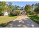 Charming single-story home featuring stone accents, a well-manicured lawn, and a long driveway at 39 Forked Pine Ct, Chapel Hill, NC 27517