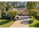 Charming single-story home featuring stone accents, a well-manicured lawn, and a long driveway at 39 Forked Pine Ct, Chapel Hill, NC 27517