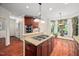 Bright kitchen with an island cooktop, pendant lighting, and ample counter space at 39 Forked Pine Ct, Chapel Hill, NC 27517
