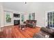 Comfortable living room with fireplace, hardwood floors, and plenty of natural light at 39 Forked Pine Ct, Chapel Hill, NC 27517