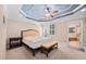 This main bedroom boasts a decorative tray ceiling, neutral color palette, and access to the ensuite bathroom at 39 Forked Pine Ct, Chapel Hill, NC 27517
