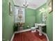 Stylish powder room with unique decor, pedestal sink, and natural light at 39 Forked Pine Ct, Chapel Hill, NC 27517
