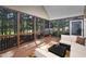 Cozy screened-in porch with comfortable seating and scenic views of the surrounding trees at 39 Forked Pine Ct, Chapel Hill, NC 27517