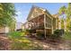 Rear exterior showing screened-in porch with backyard landscaping and lush lawn at 39 Forked Pine Ct, Chapel Hill, NC 27517