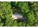 Aerial view of home nestled among dense green trees, showcasing privacy and serene setting at 4022 Tecolote Way, Hillsborough, NC 27278
