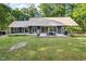 Spacious backyard with a concrete patio featuring an outdoor dining set and grill at 4022 Tecolote Way, Hillsborough, NC 27278