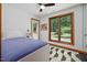 Comfortable bedroom with outdoor access and scenic views through large windows at 4022 Tecolote Way, Hillsborough, NC 27278