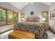 Sun-drenched bedroom with bright sunflower bedding and large windows overlooking the lush greenery at 4022 Tecolote Way, Hillsborough, NC 27278