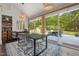Dining area boasts large windows overlooking the backyard and stylish lighting fixtures at 4022 Tecolote Way, Hillsborough, NC 27278