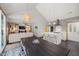 Open-concept kitchen with island seating, modern lighting, and a seamless flow to the dining and living areas at 4022 Tecolote Way, Hillsborough, NC 27278