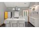 Bright kitchen features sleek appliances, white cabinets and an island with bar stool seating at 4022 Tecolote Way, Hillsborough, NC 27278