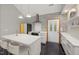 Modern kitchen with white cabinets, quartz countertops, stainless steel appliances, and stylish subway tile backsplash at 4022 Tecolote Way, Hillsborough, NC 27278