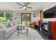 Cozy living room features a plush sectional sofa, large windows, and modern entertainment center at 4022 Tecolote Way, Hillsborough, NC 27278