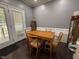 Cozy dining area with a wooden table set for four, complemented by natural light and built-in display cabinet at 4057 Old Franklinton Rd, Franklinton, NC 27525