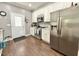 Modern kitchen with white cabinets, stainless steel appliances, and a sleek hardwood floor for a timeless aesthetic at 4057 Old Franklinton Rd, Franklinton, NC 27525