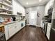 Well-lit kitchen featuring white cabinetry, granite countertops, stainless steel appliances, and hardwood flooring at 4057 Old Franklinton Rd, Franklinton, NC 27525