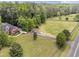 Sprawling property featuring a brick home, expansive lawn, and forested area at 412 Bowen Rd, Rougemont, NC 27572