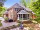 Brick home featuring a cozy screened-in porch and a brick patio with outdoor seating at 412 Bowen Rd, Rougemont, NC 27572