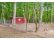 Backyard with a shed enclosed by a wire fence and surrounded by trees at 412 Bowen Rd, Rougemont, NC 27572