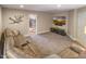 A spacious finished basement with a large sectional couch, TV, and access to the home gym at 412 Bowen Rd, Rougemont, NC 27572