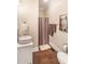 Bathroom featuring wood floors, a white sink vanity, and a shower with a patterned curtain at 412 Bowen Rd, Rougemont, NC 27572