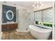 Contemporary bathroom with a glass shower, soaking tub, floating vanity, and modern lighting, offering a luxurious experience at 412 Bowen Rd, Rougemont, NC 27572