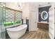 Sleek bathroom featuring a modern tub, glass shower, floating vanity, and stylish fixtures, designed for comfort and elegance at 412 Bowen Rd, Rougemont, NC 27572