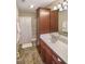 Bathroom featuring a dark vanity with ample storage, a white countertop and a tub shower at 412 Bowen Rd, Rougemont, NC 27572