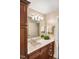 Bathroom with a dark vanity with ample storage, a white countertop, a decorative plant, and ample lighting at 412 Bowen Rd, Rougemont, NC 27572
